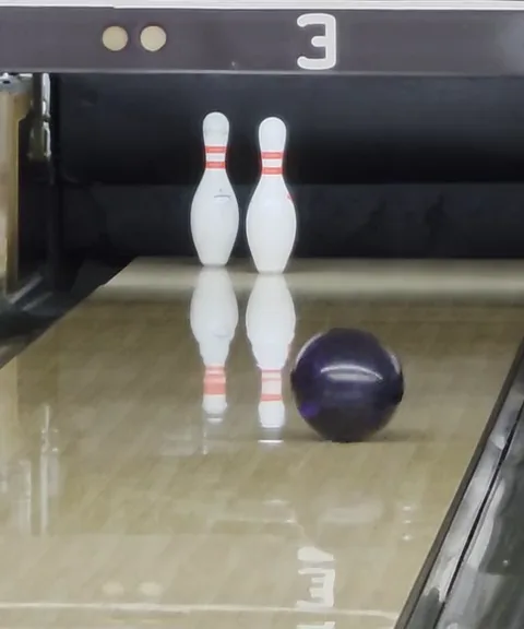 Your lane: the ball rolling toward the 2 and 4 pins, left standing for the spare.